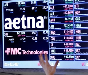 A trader points up at a display on the floor of the New York Stock Exchange August 20, 2012. REUTERS/Brendan McDermid